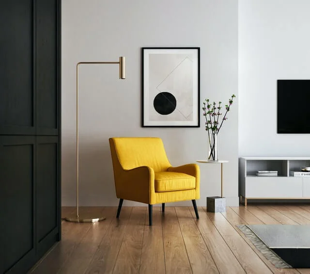 Modern interior designed by DG Interior Space - interior designers in Delhi, featuring a bright yellow armchair and minimalist decor.